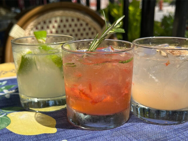 three cocktails sit on a patio table at biffs bistro