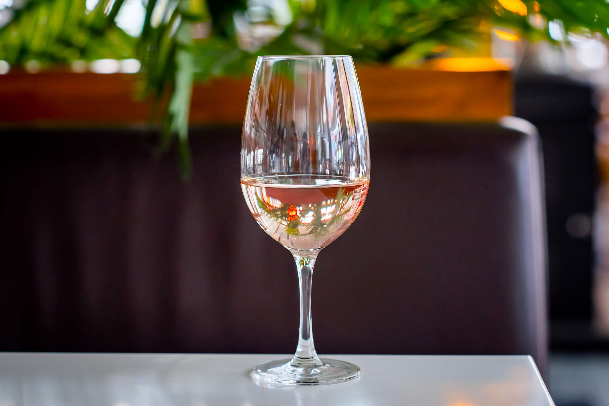 close up rosé in wine glass with blurred background