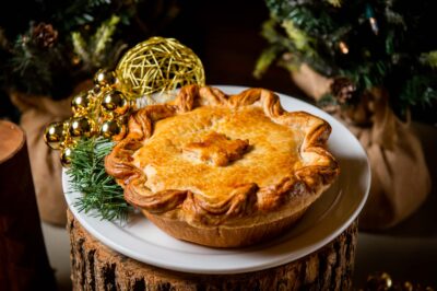 Tourtiere on wooden pedestal with holiday foliage at canteen toronto