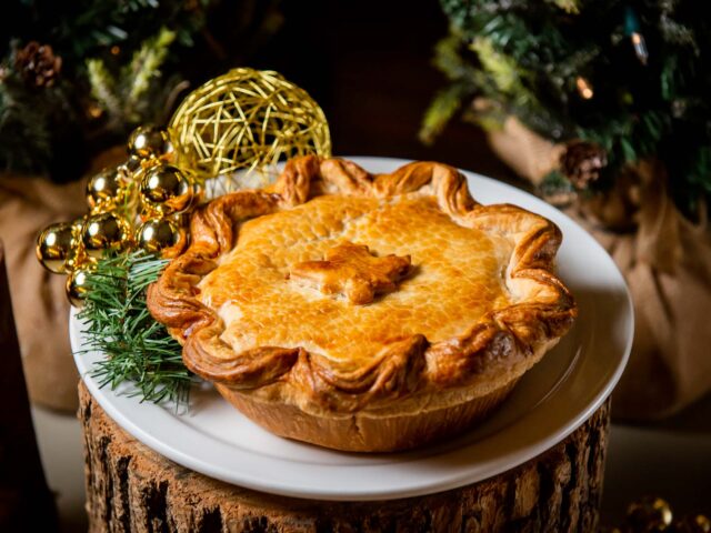 Tourtiere on wooden pedestal with holiday foliage at canteen toronto