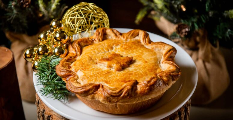 Tourtiere on wooden pedestal with holiday foliage at canteen toronto
