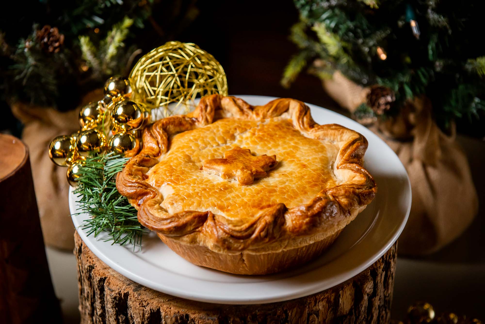 Tourtiere on wooden pedestal with holiday foliage at canteen toronto