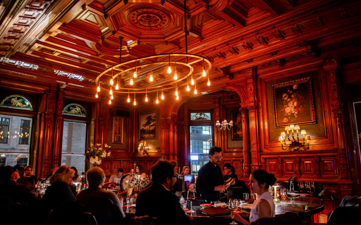 a group of people sitting at a table in a restaurant