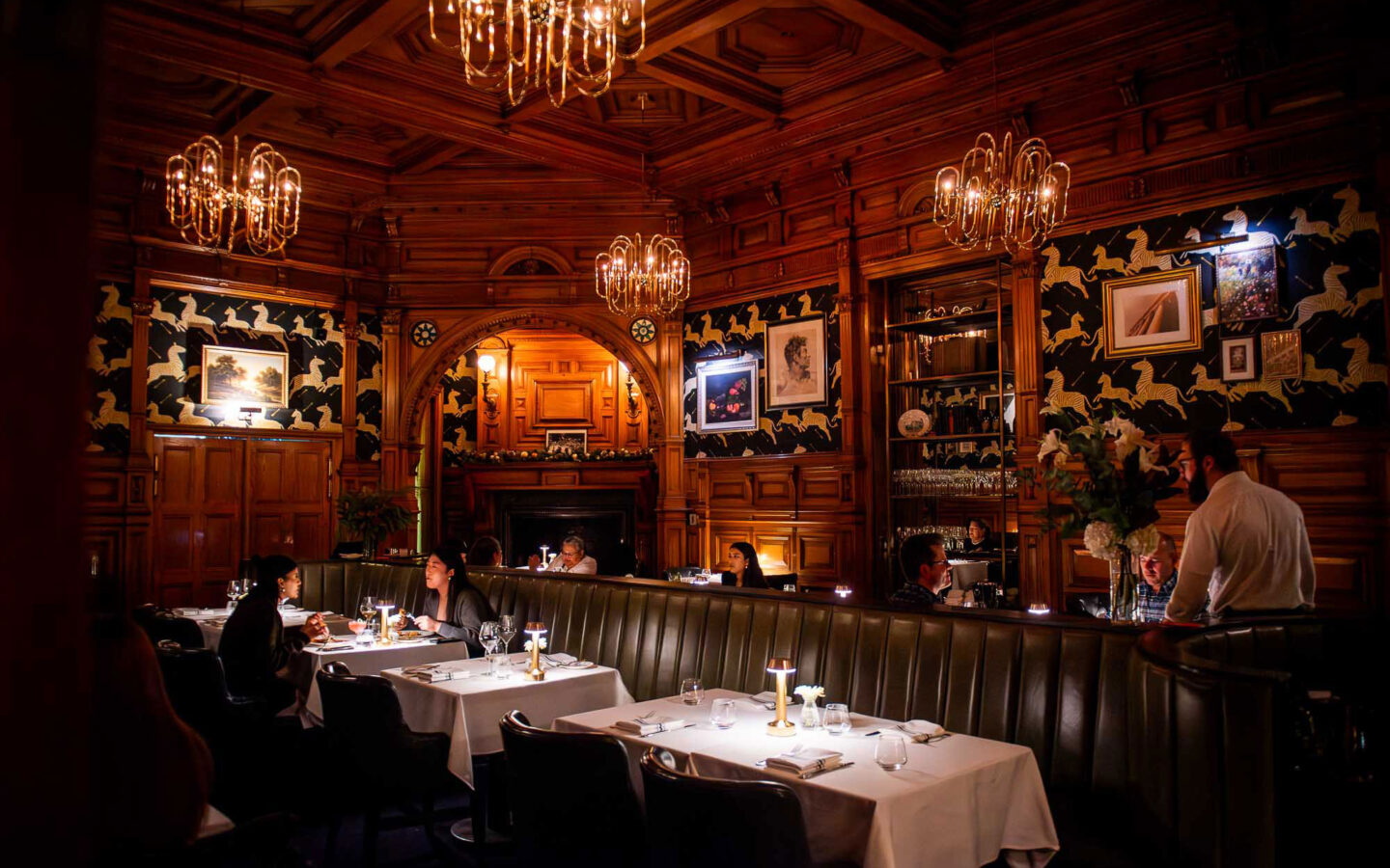 a dining room with tables and chairs and a chandelier