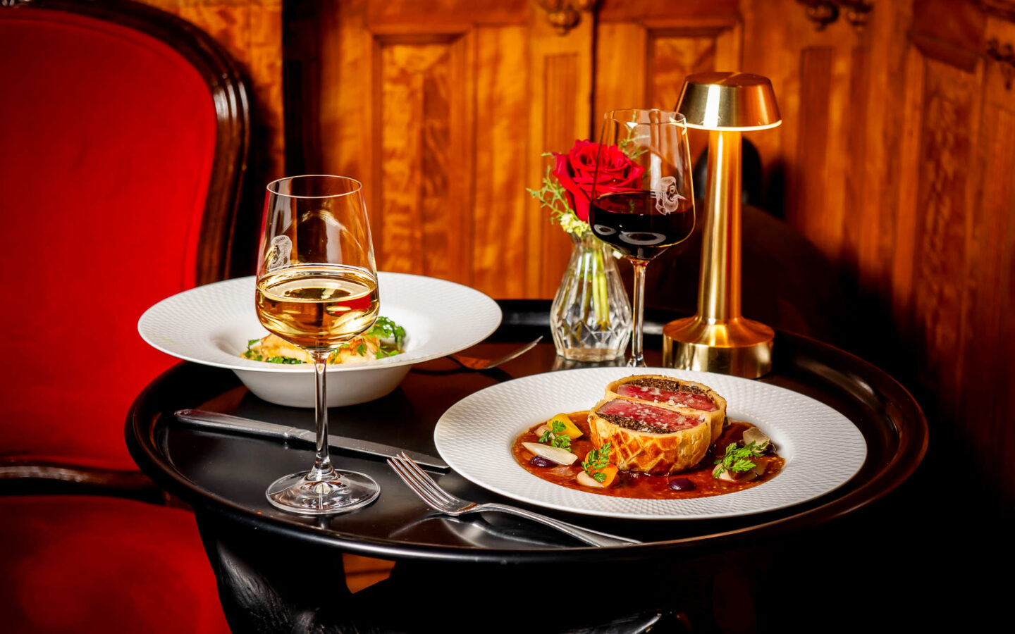 dish plates of food sit atop a black table 