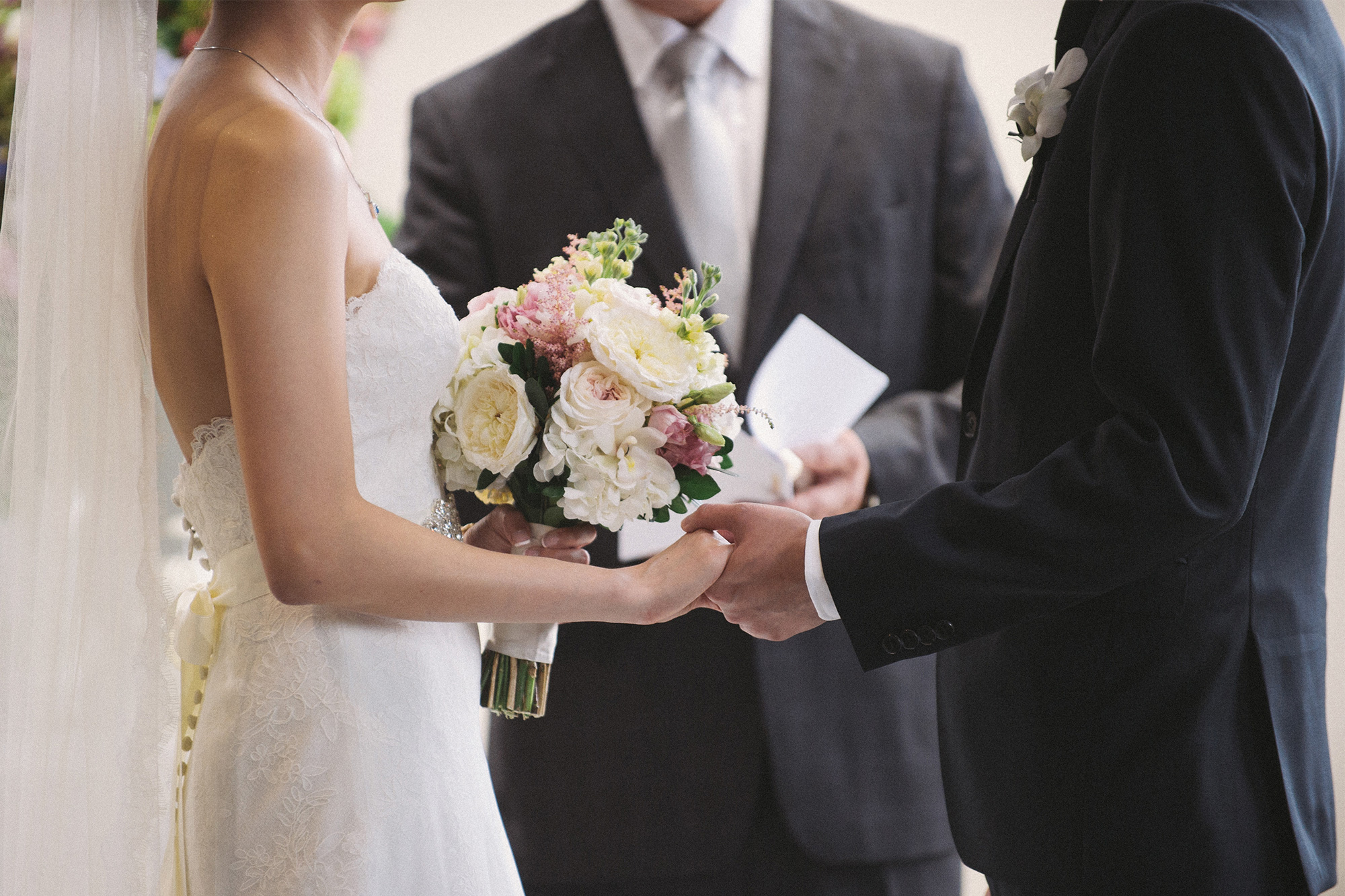 Couple holding hands during their wedding ceremony