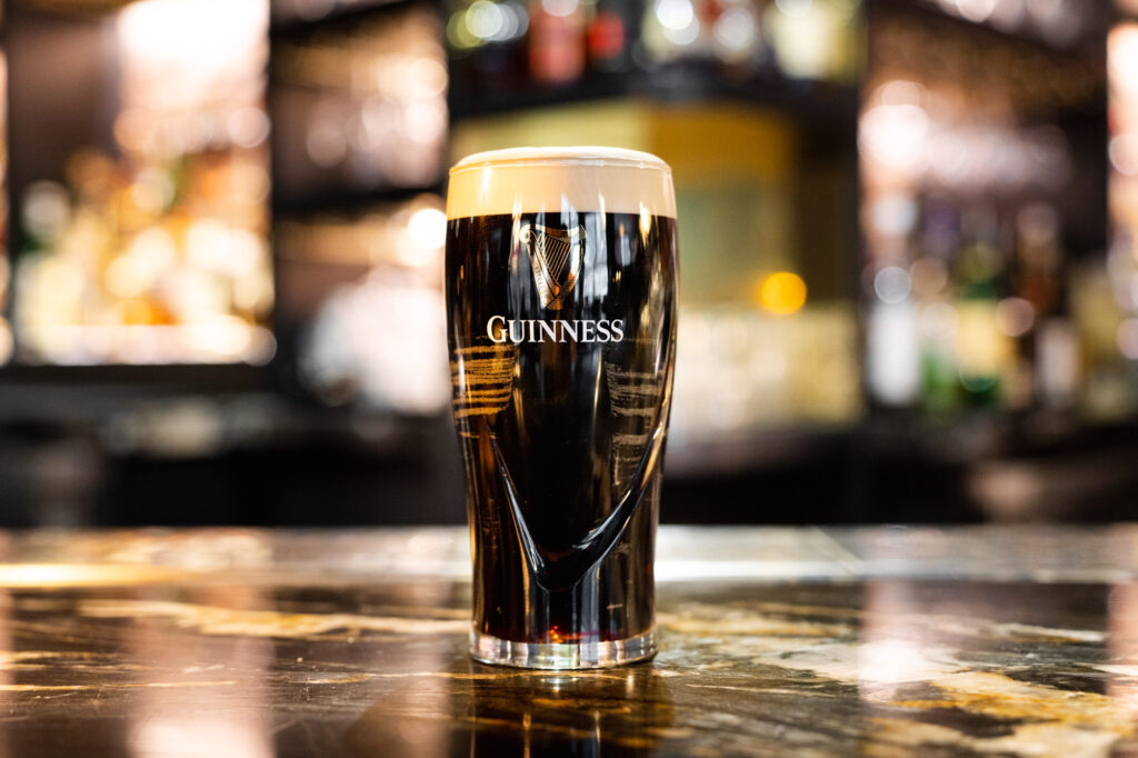 pint of guinness with The Rabbit Hole bar in the backdrop