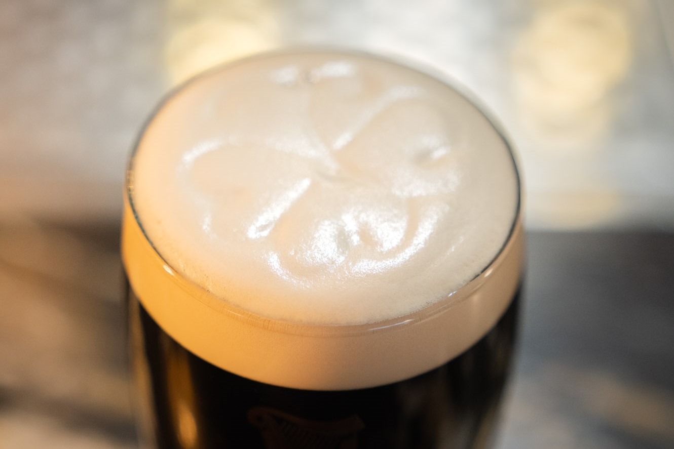 Foam of a Guinness with a shamrock design