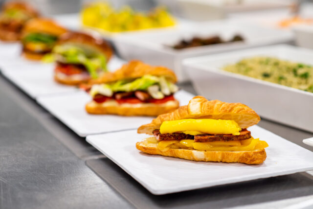 diagonal row of sandwiches on white square plates