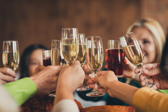 Full happy family clinking glasses thanks giving party garnished turkey dinner table house living room indoors