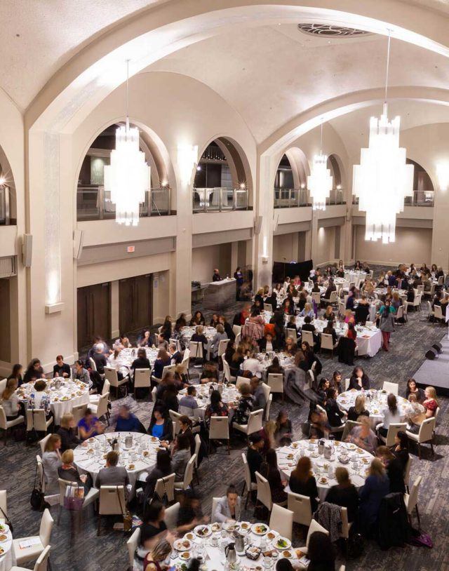 several tables with people at a corporate event at arcadian court venue