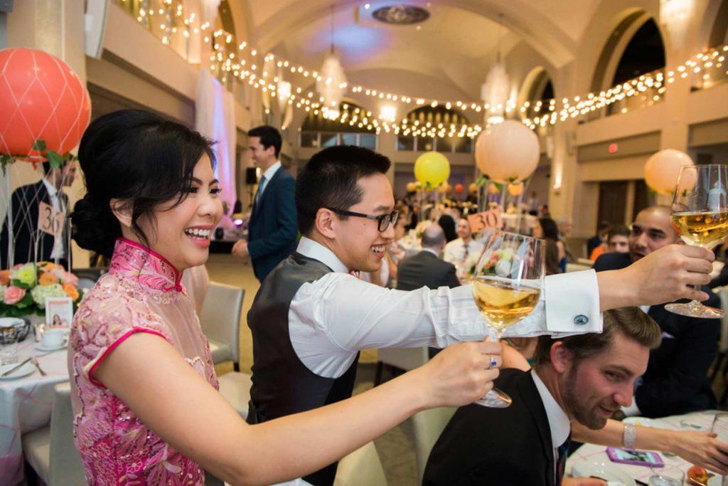 Guests raising their glasses of wine at a wedding reception at Arcadian Court