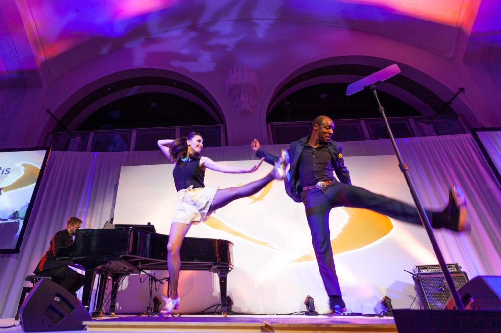 Tap dancers performing on stage in Arcadian Court