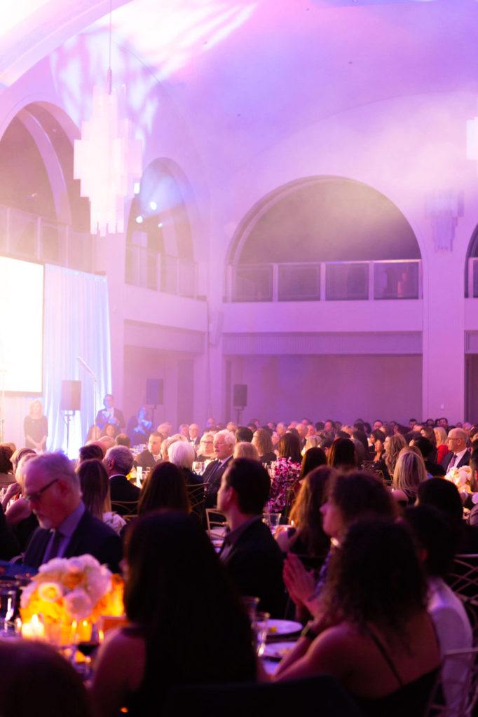 Guests observing a performance at a gala event in Arcadian Court