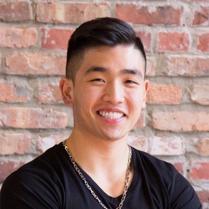 headshot of Chef Eric Chong standing against a brick wall