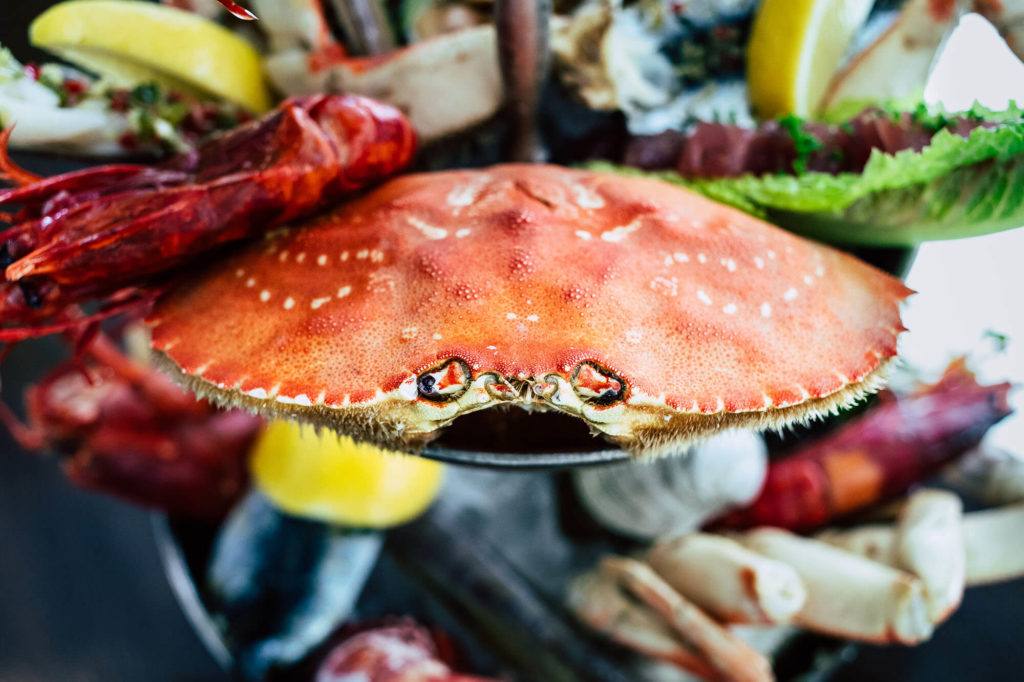 crab sitting on seafood tower