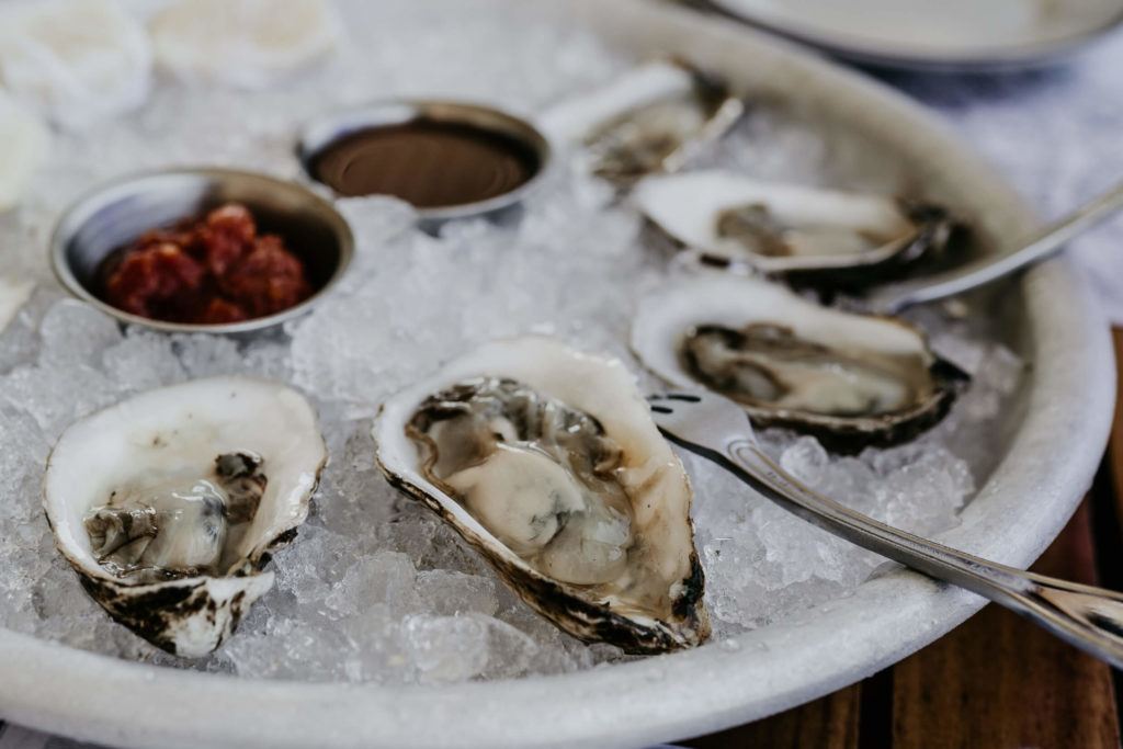 Platter of oysters on a wooden table