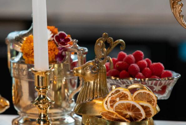 Alchemy bar topped with fresh fruit, dried citrus, candlesticks and decorative pieces.