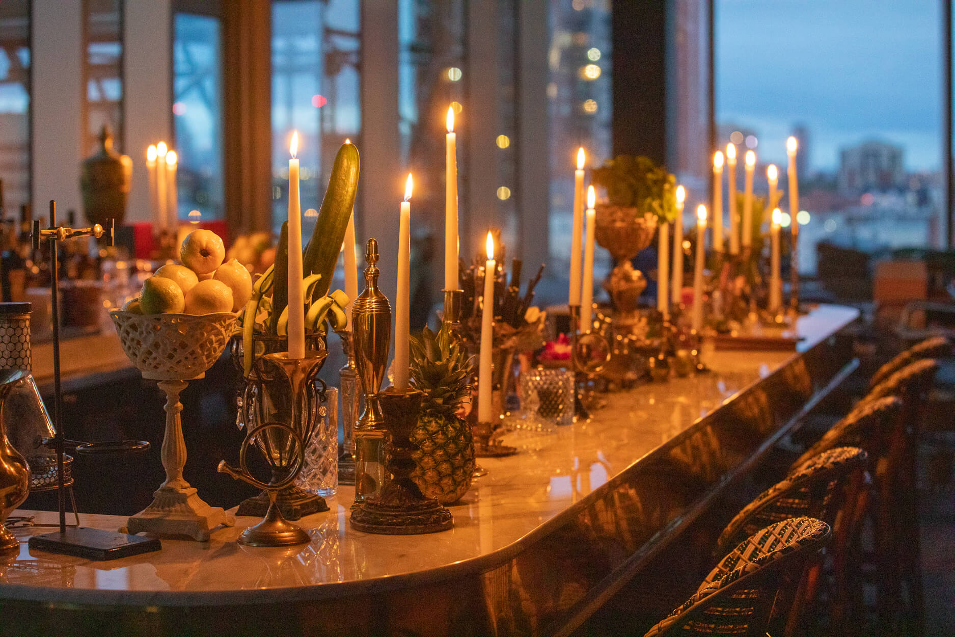 Alchemy bar lined with candles at dusk in downtown Edmonton