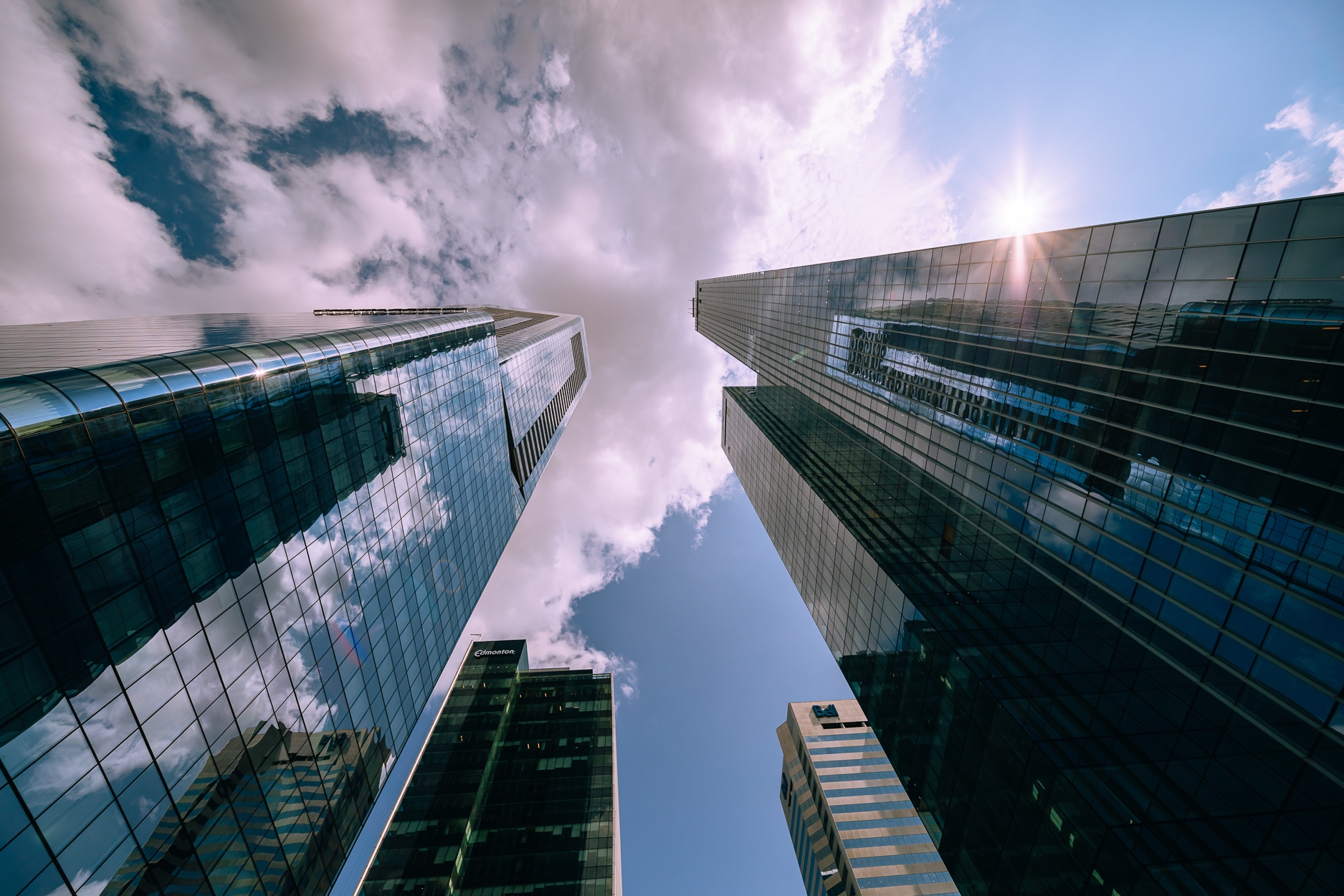 upward view flanked with blue glass sky scrapers