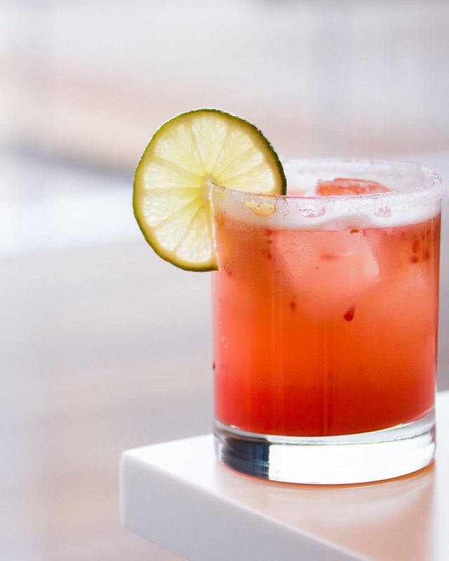 salt-rimmed cocktail with lime wheel