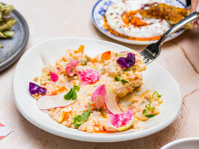 sea bass tartare garnished with radish and edible flowers