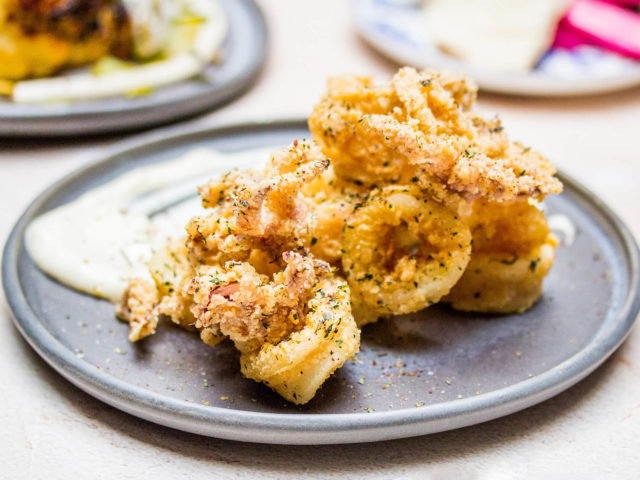 Fried squid on a light grey plate at Babel restaurant