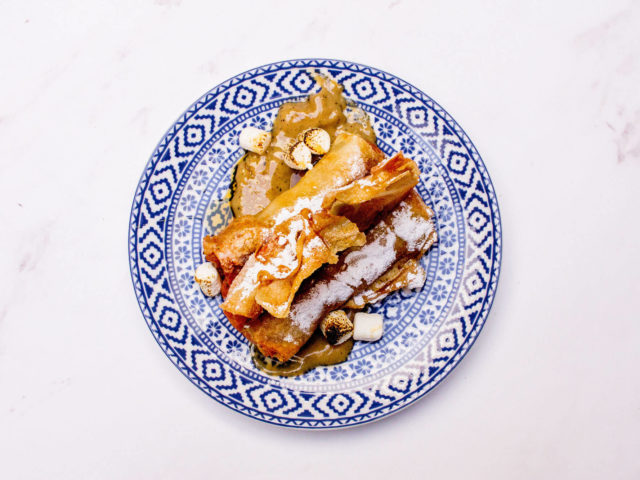 sweet potato spring rolls garnished with marshmallow and maple syrup