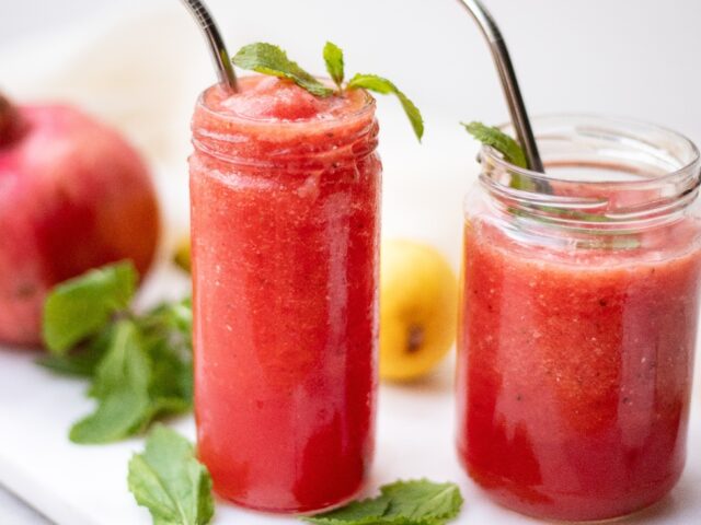 mason jars of frozen cocktails with straws